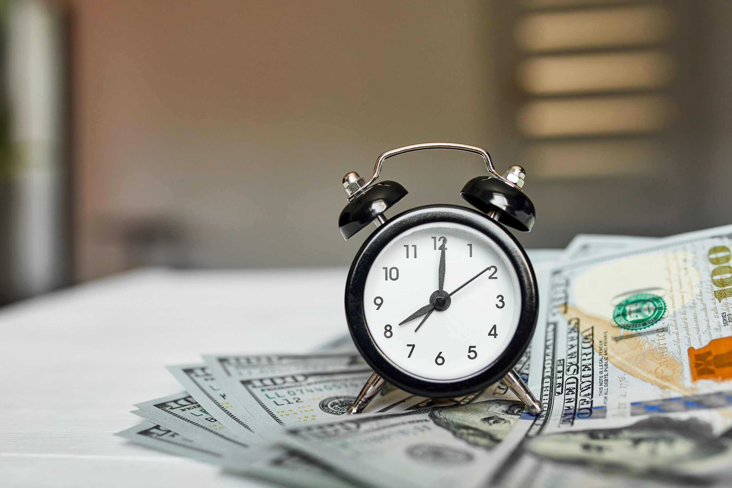 top-view-flat-lay-of-alarm-clock-and-money-on-whit top-view-flat-lay-of-alarm-clock-and-money-on-whit